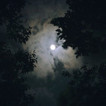 Black Moon Lilith in Aries represented by a full moon in a dark sky.