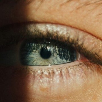 Black Moon Lilith in Taurus symbolized by a half-lit eye and shadow, representing desire, control, and embodiment