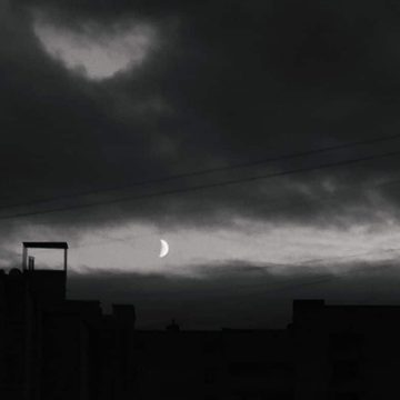 Black moon Lilith in Gemini represented by a dark night sky with the moon.