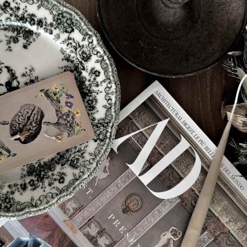 able setting featuring a tarot card, a design-related journal, and aesthetic details.