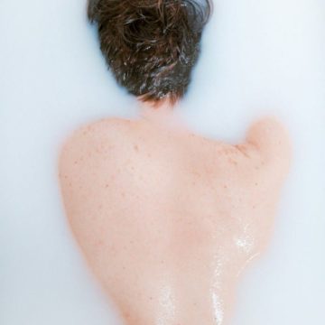 Neptune in the 5th house in your birth chart, dreamy and blurred figure in water symbolizing romance, creativity, and fantasy.