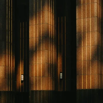 Neptune in the 8th house symbolism with dark architectural shadows and light.