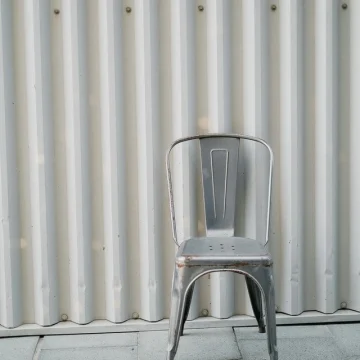 Neptune in the 11th house symbolism with empty chair and structured background.