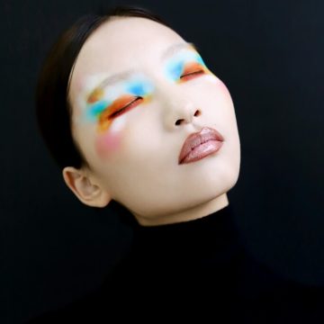 Neptune in the 3rd house symbolism shown through a dreamlike portrait with blurred, colorful eye makeup.