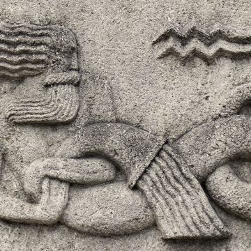 Pluto in Aquarius represented on a rock.