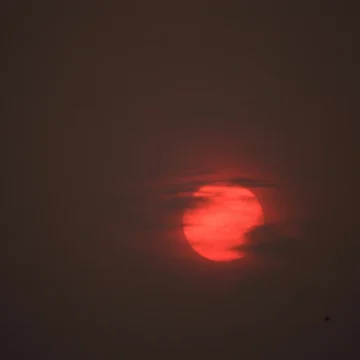 sagittarius full moon energy, deep red full moon in a dark night sky symbolizing intensity, truth, and emotional culmination