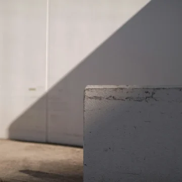 saturn return grey background representing suspension and stillness, minimal and atmospheric, soft gradients and empty space symbolizing pause.