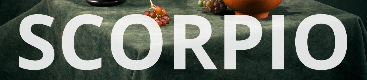 Scorpio horoscope banner. Still life scene with grapes, pottery, and dark green fabric.