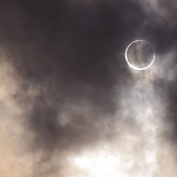 Full Moon in Pisces in a cloudy sky.