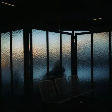 Taurus season grounding energy, dark window at sunset with warm light creating a calm atmosphere.