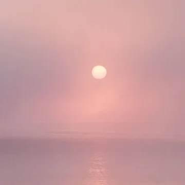 Moon in a pink sky to represent the Moon in the 12th house in a birth chart.