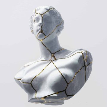 Venus in Aries transit symbolized by a cracked marble statue with gold lines representing passion and desire.