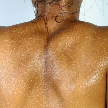 zodiac body parts astrology, woman seen from behind with bare shoulders