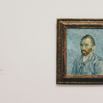 Framed portrait of Vincent van Gogh displayed on a white gallery wall